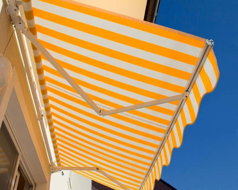A yellow and white striped awning hung outside a door.