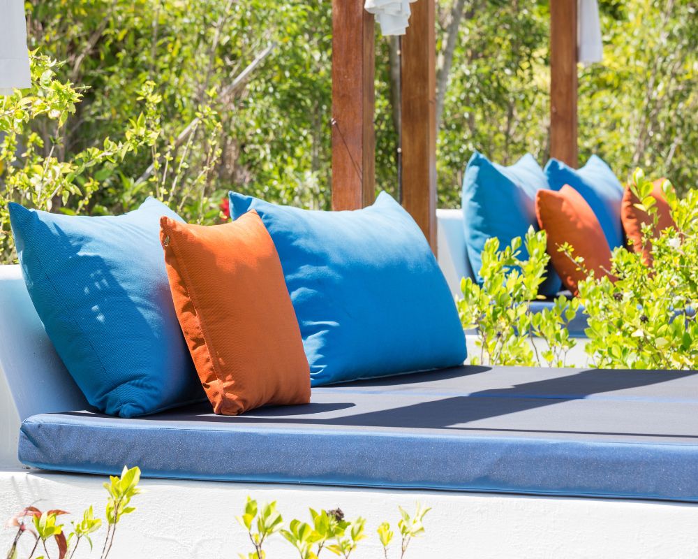 Outdoor loungers with bright colored sun resistant fabric pillows.